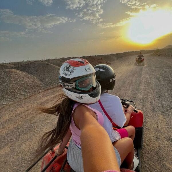 Quad 3 Hours Safari Hurghada featuring a couple taking a selfie on a quad bike during the golden sunset