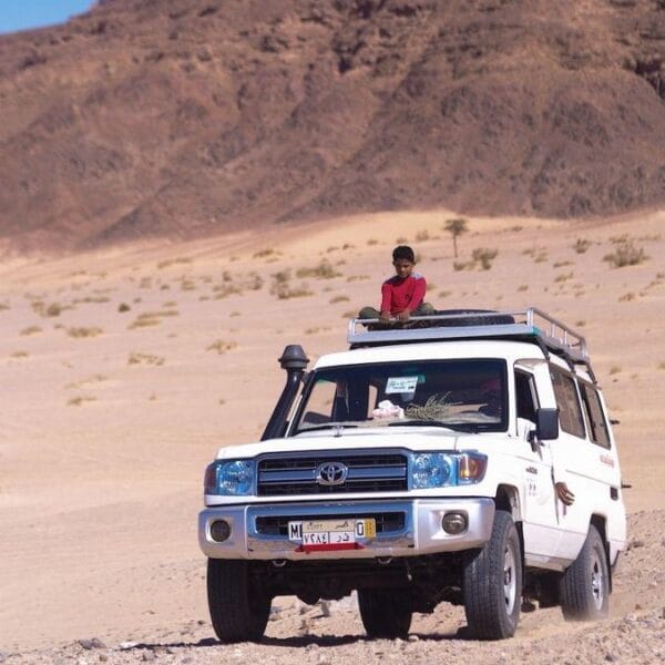 Super Safari Hurghada adventure with a white 4x4 Jeep Land Cruiser driving through the desert mountains