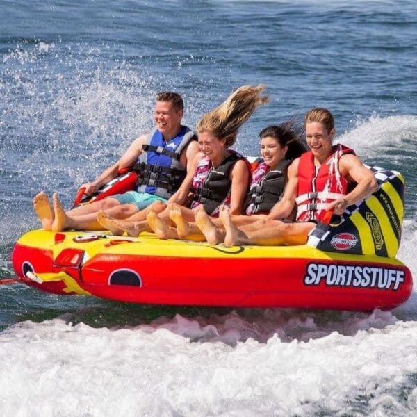 Banana and Sofa Boat Hurghada: A group of friends laughing and enjoying a fast sofa boat ride over the splashing waves of the Red Sea