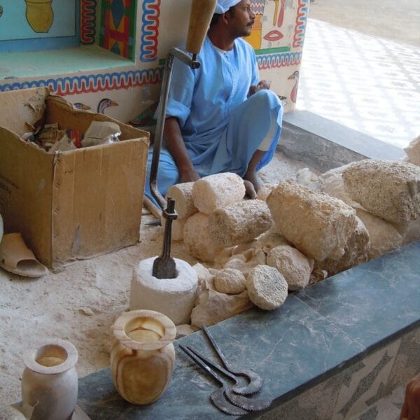 Luxor Over Day: An Egyptian craftsman working on traditional handmade alabaster vases in a workshop in Luxor