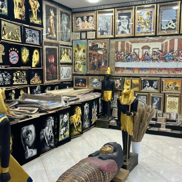 Luxor Over Day: An upscale Egyptian souvenir gallery in Luxor featuring framed papyrus art, life-sized statues, and pharaonic replicas