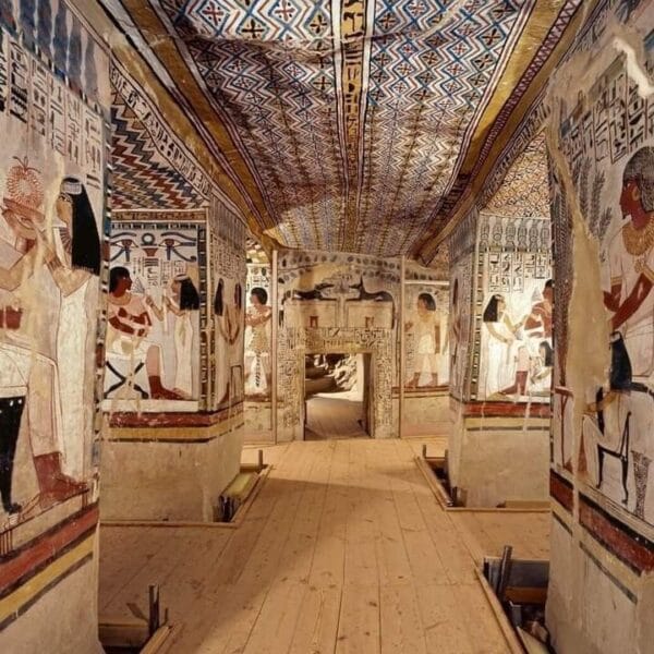 Luxor Over Day: The interior of an ancient Egyptian tomb in the Valley of the Kings, showcasing vibrant wall paintings and intricately decorated ceilings