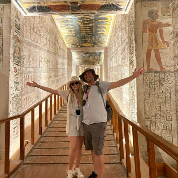Luxor Over Day: A couple posing inside a beautifully decorated ancient Egyptian tomb with colorful hieroglyphics in the Valley of the Kings