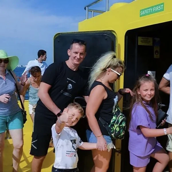 Tourists and families board the yellow Royal Submarine to begin their cruise